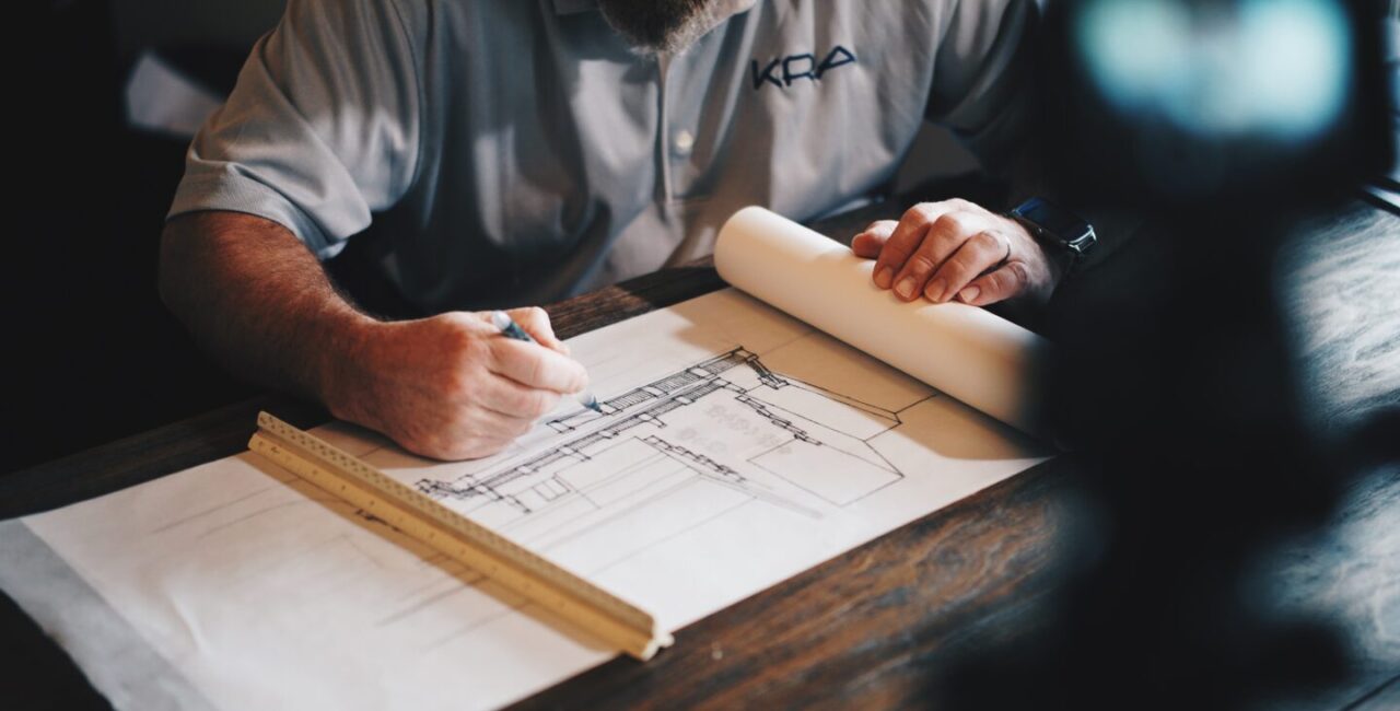 The construction contractor works with some drawings in the office