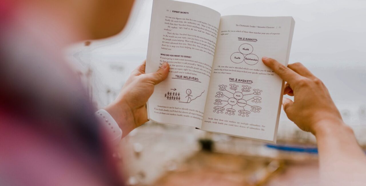 Man is reading the book about a marketing