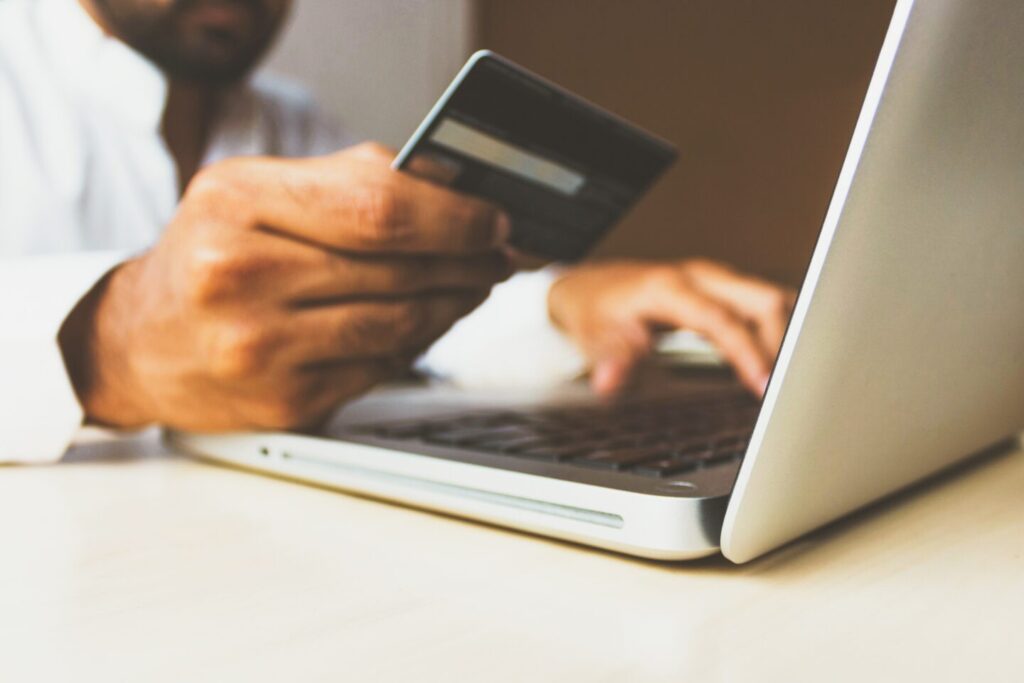 A human is paying by credit cards because he bought product on ecommerce website