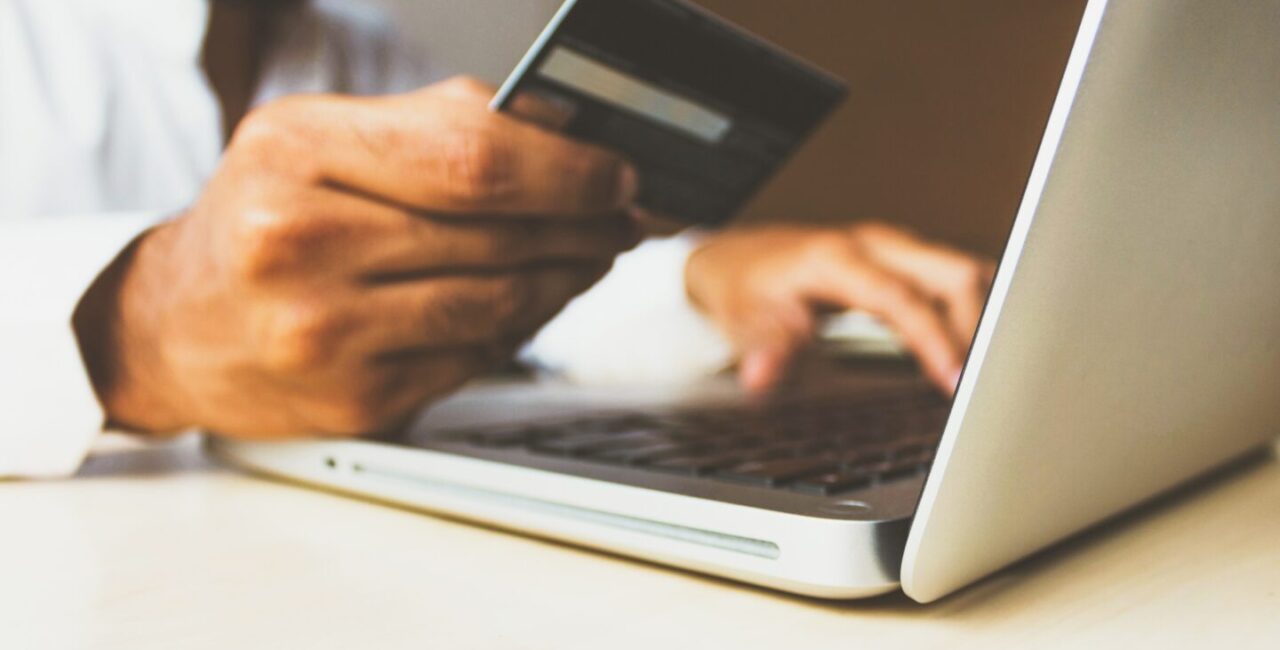 A human is paying by credit cards because he bought product on ecommerce website