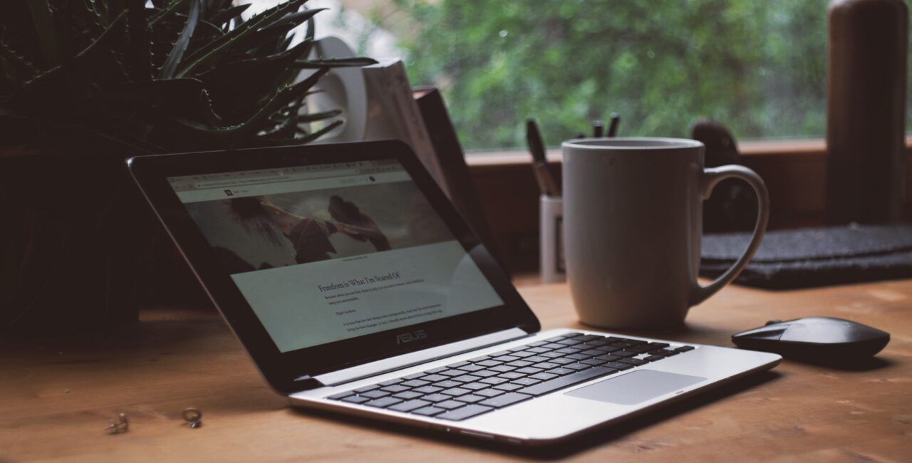 The laptop on the desk, cup of tea that symbolize the work on anchor for SEO purposes