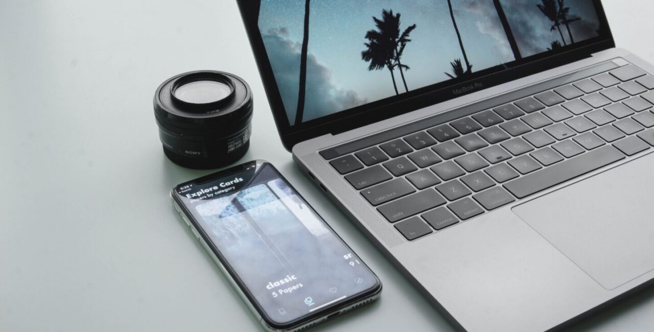 Laptop and mobile phone on the white desk are equipment for SEO specialist who want to improve rank of a website