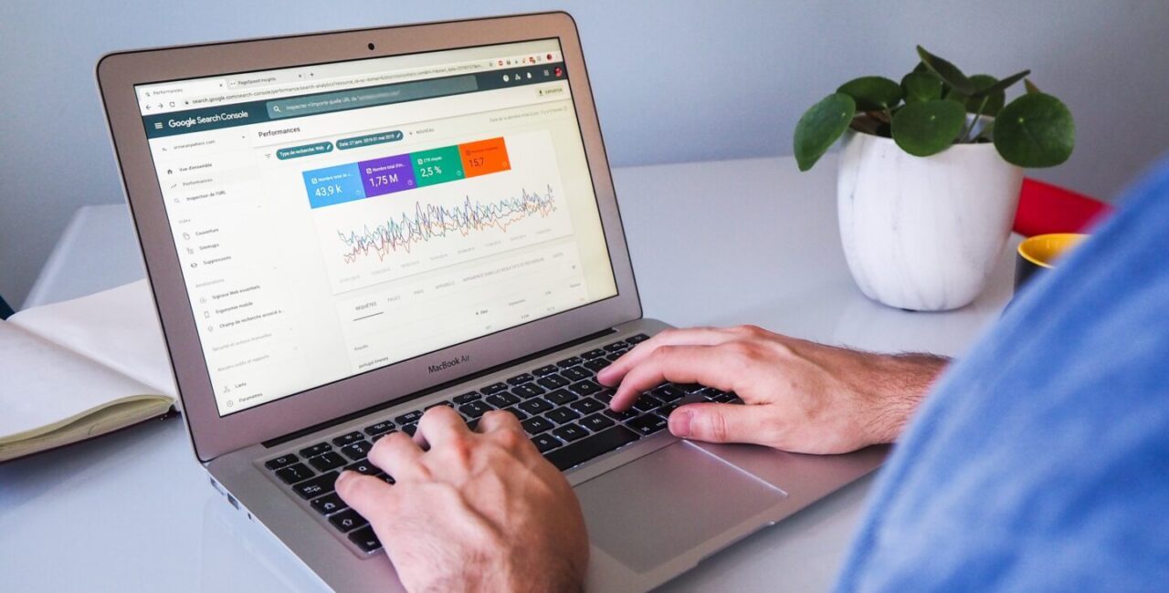 The man use a laptop to check the data from Google search Console that helps him to provide SEO audit of a site