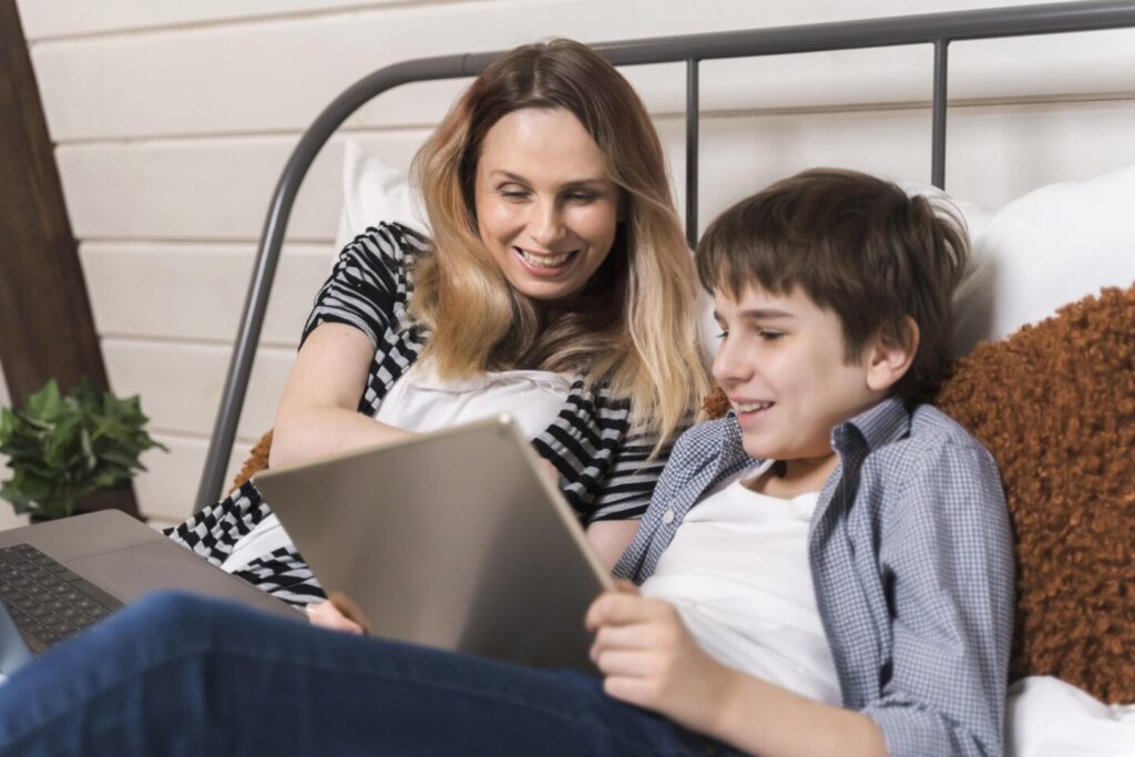 Happy mom and her son are playing math games on tablet PC