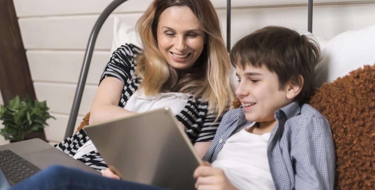 Happy mom and her son are playing math games on tablet PC