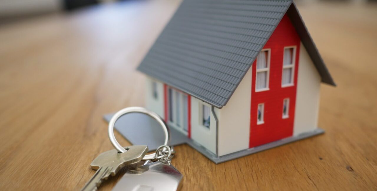 The little white playhouse with real key on the wood desk