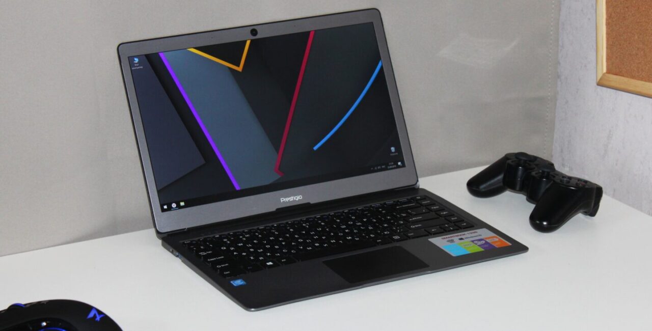 A black laptop on a white desk