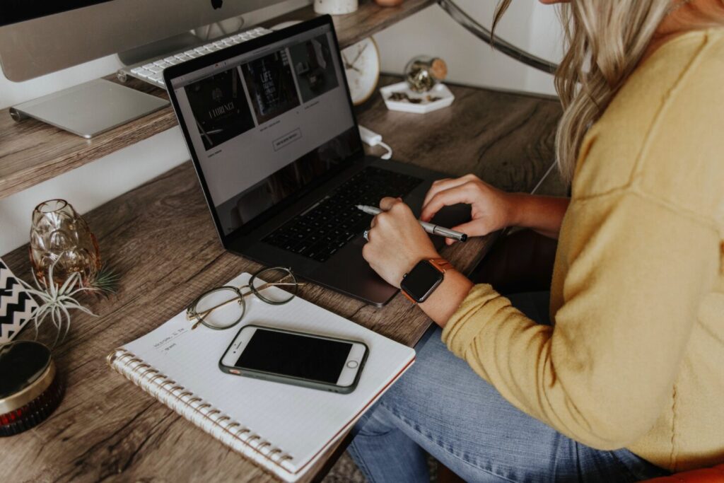 A woman uses a laprop to calculate the price of website development