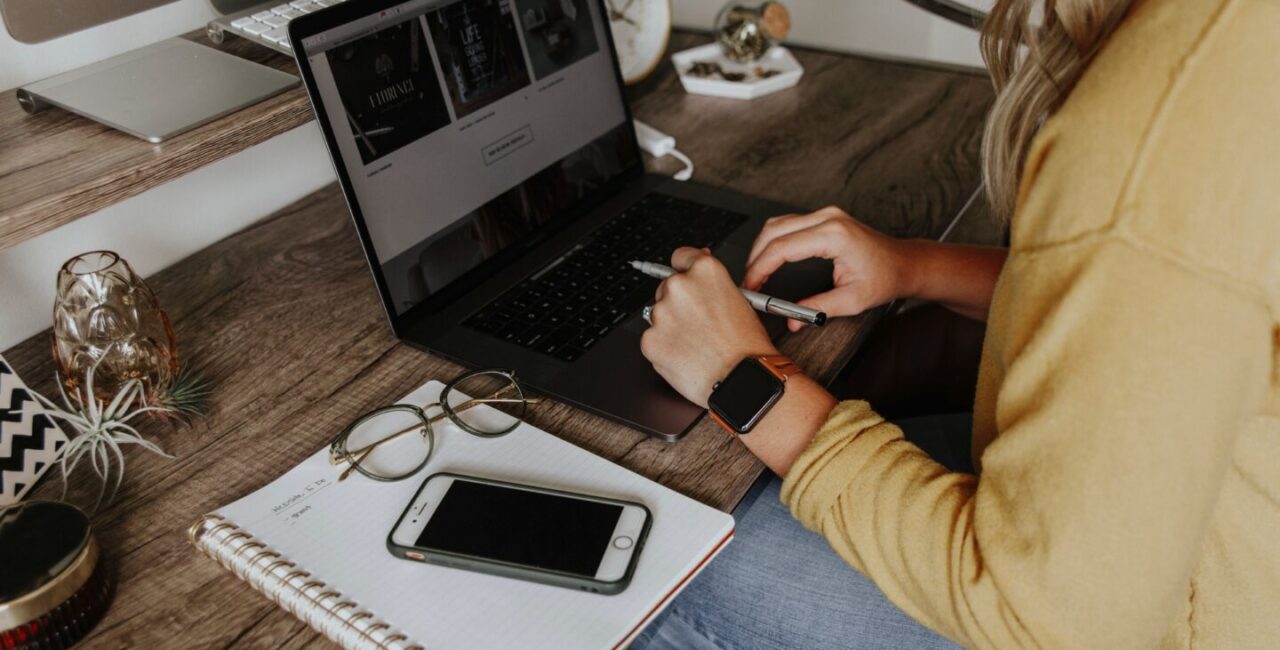 A woman uses a laprop to calculate the price of website development