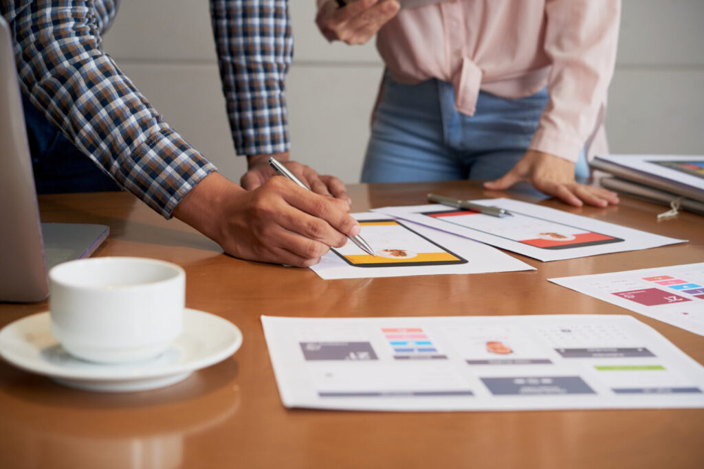 Hands of product manager making corrections on interface image