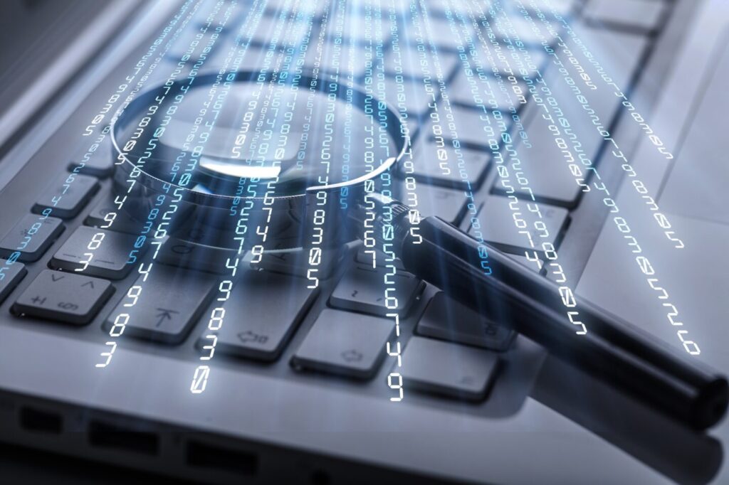Magnifying glass on laptop computer keyboard