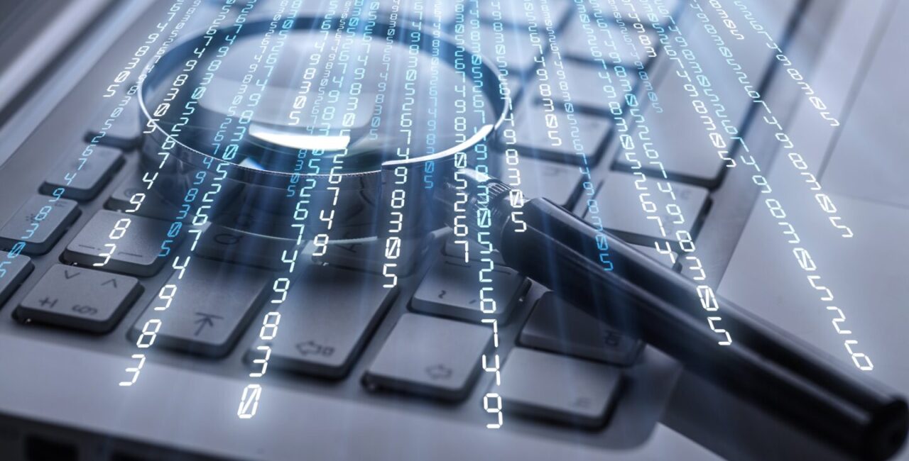 Magnifying glass on laptop computer keyboard