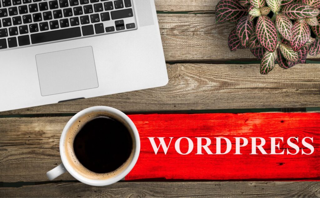 top view of coffee cup and keyboard with wordpress inscription on table