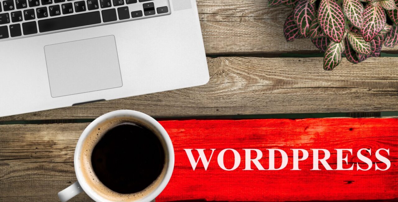 top view of coffee cup and keyboard with wordpress inscription on table