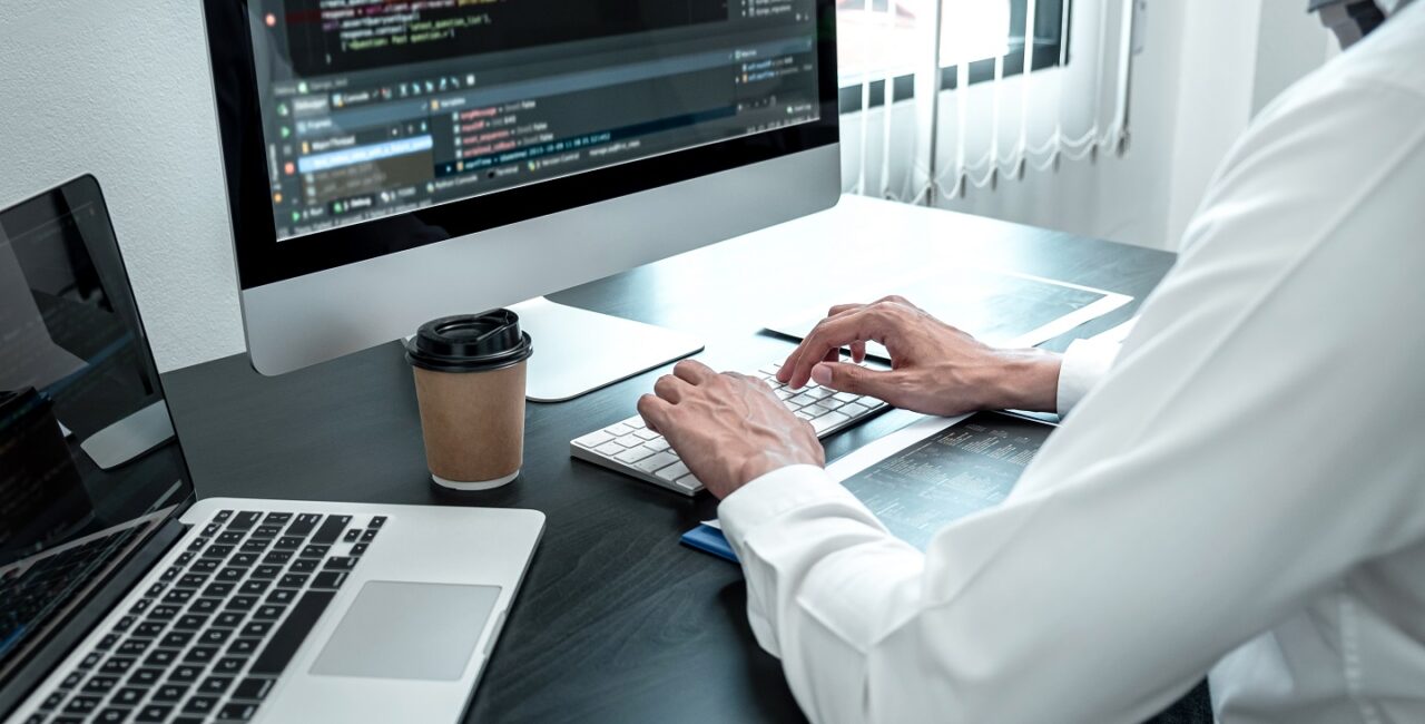 Young Programmer working in software javascript computer in IT office, Writing codes and data code website and coding database technologies to find solution to problem.