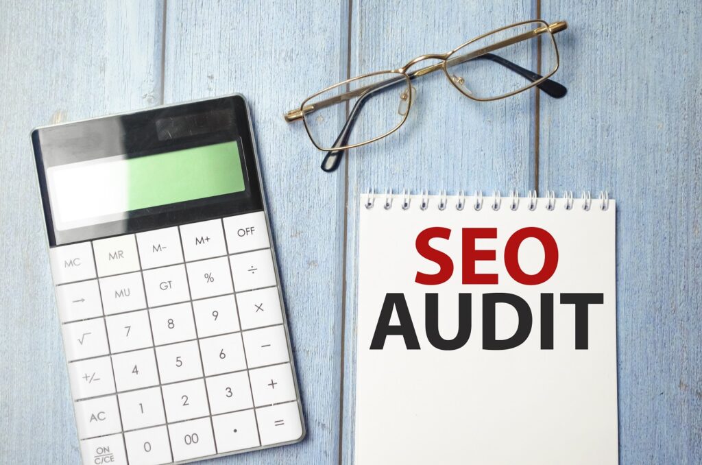 The business card is on the calculator, on it the SEO AUDIT