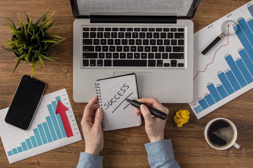 top view office desk with laptop growth chart