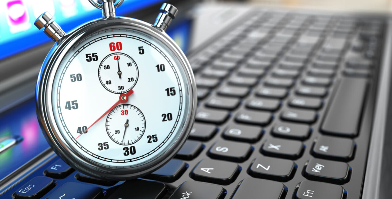 Stopwatch on laptop keyboard. Website speed optimization concept.