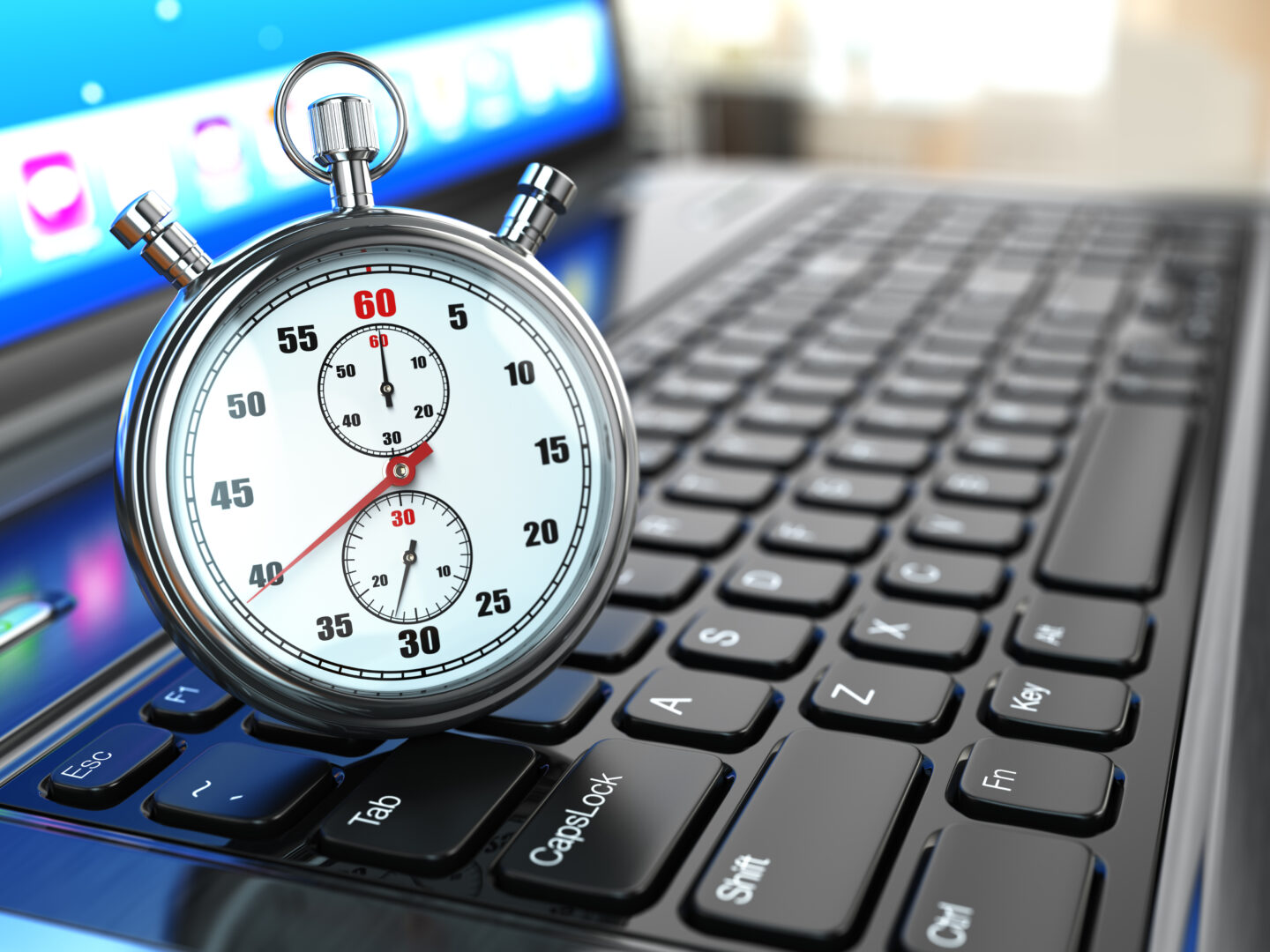 Stopwatch on laptop keyboard. Website speed optimization concept.